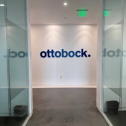 Dimensional acrylic lobby letters installed on a reception wall.