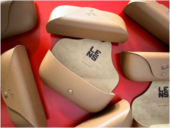 Branded accessory cases arranged on a red background.