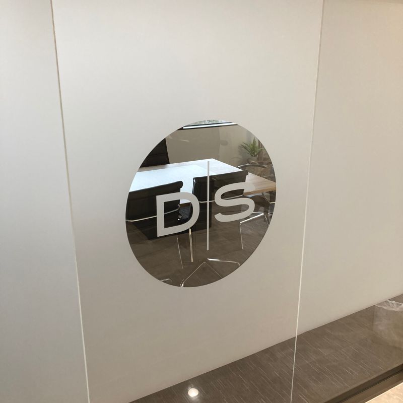 Frosted logo privacy film installed on office glass.