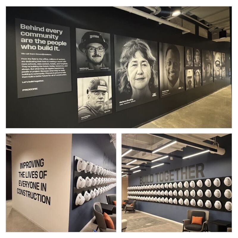 Corporate interior wall graphics and display panels installed along a hallway.