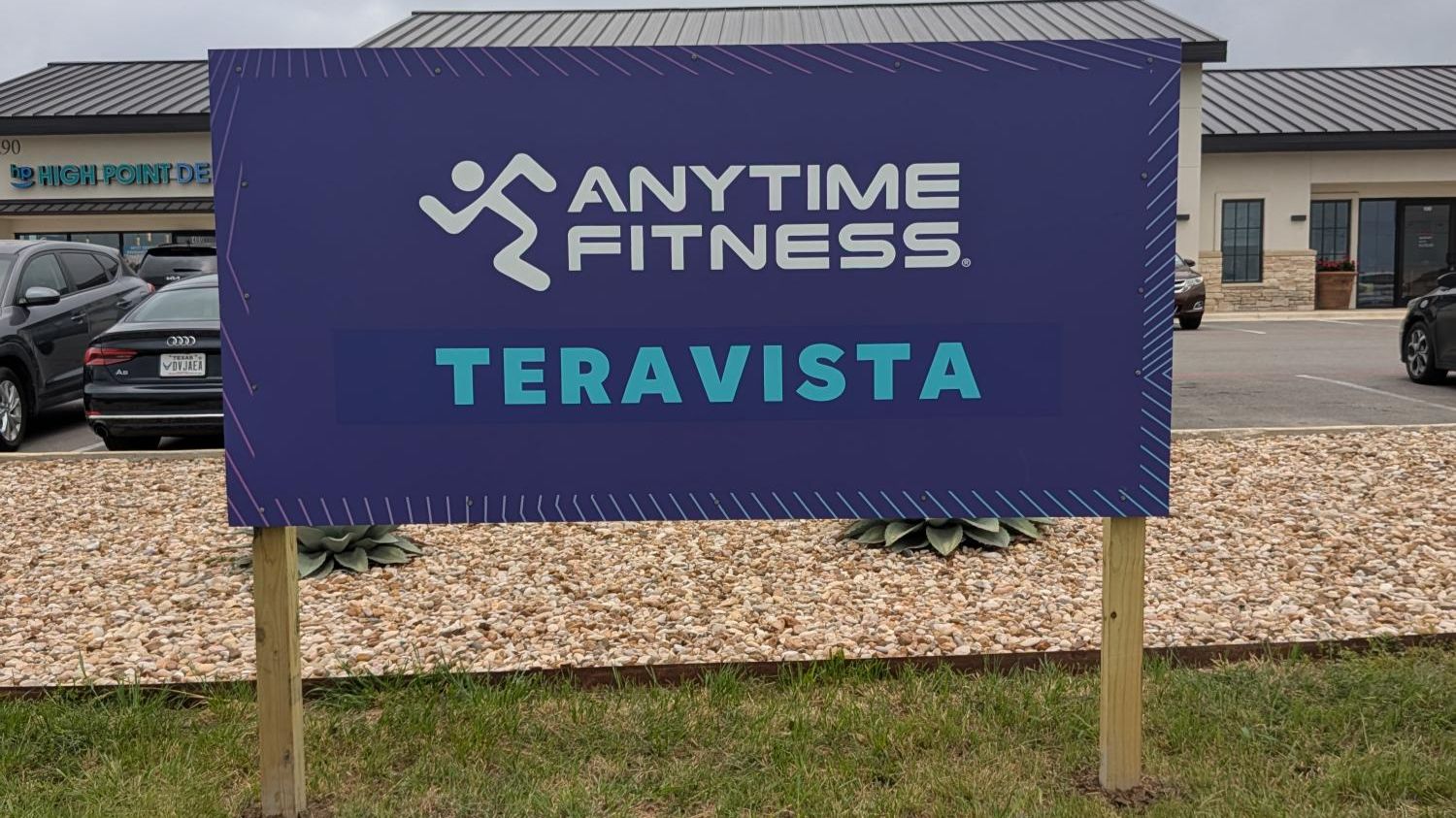 Post and panel sign for Anytime Fitness at a new location.