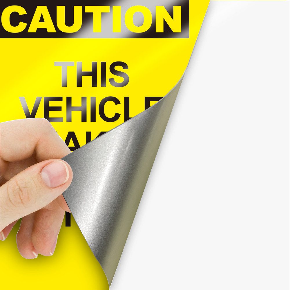 Reflective vehicle decal material being peeled back.