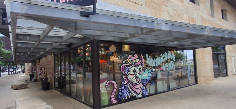 Retail window graphics applied to a corner storefront in Austin.