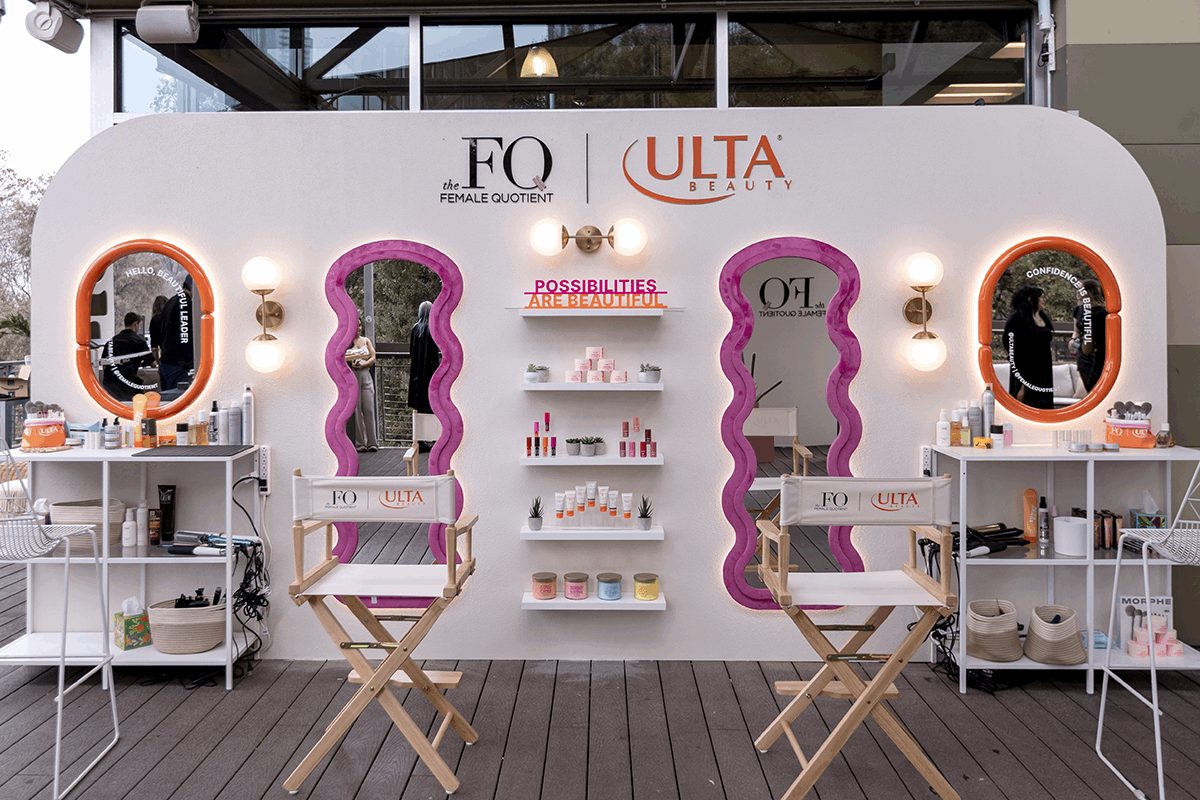 Branded activation display with printed graphics and product shelves.